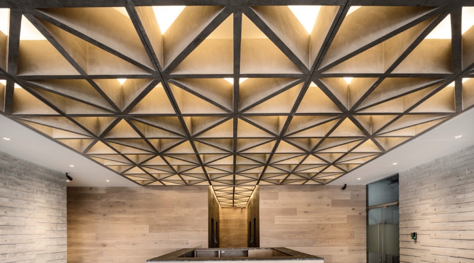 Architectural reception · custom wood ceiling, oak paneling, and integrated millwork